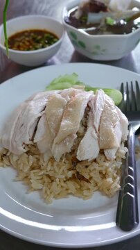 Hainanese Chicken Rice Served on Table in Restaurant. Asian Traditional Food.