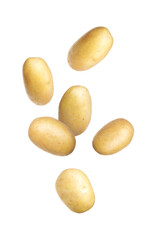 Fresh raw potatoes falling on white background