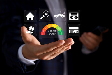 Credit score concept, businessman holding virtual screen of credit score icon for chart with credit history values. Online credit score ranking check. student loan, mortgage and payment cards.