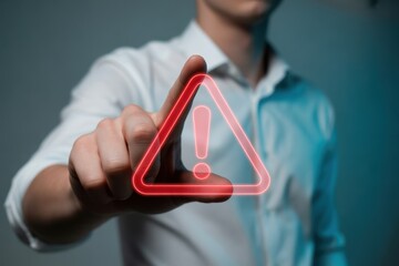 Man touching a glowing red warning sign highlighting potential risks and hazards with futuristic technology and modern business approach