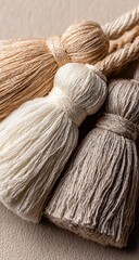 Close-up of three natural-toned tassels