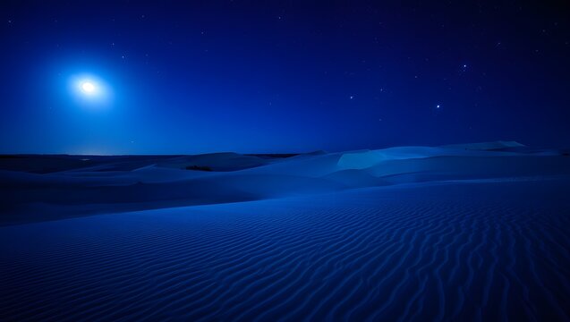 Vast desert dunes under a bright full moon at night