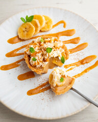 Banoffee tart filled with caramel, fresh banana and whipped cream.