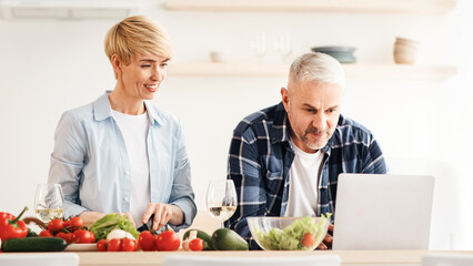 Search for recipe on Internet, cook food and communicate with blog followers. Concentrated middle...