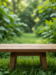 Naklejka premium A wooden table product display with lush green garden background of grass, leaves and blurred foliage.
