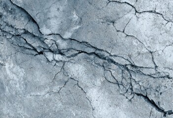Cracked concrete surface texture in shades of gray.