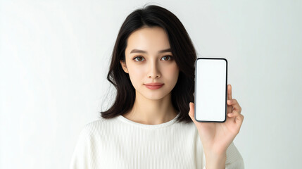 Fototapeta premium Japanese woman holding smartphone with gentle smile 
