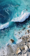 High-angle view of azure waves crashing on a rocky shore
