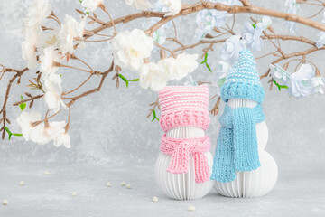 Happy snowmen under a sakura branches. Greeting card, Valentine's Day concept, lovers anniversary