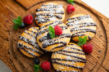 Butter and coconut cookies decorated with chocolate and grated coconut.