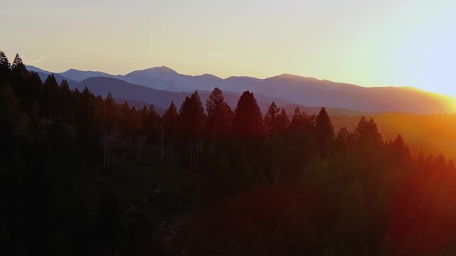 Mount Blue Sky front range Mt Evans peak aerial drone Evergreen Colorado scenic bypass golden hour sunset sun flare Rocky Mountains layers Arapaho National Forest spring summer parallax right motion
