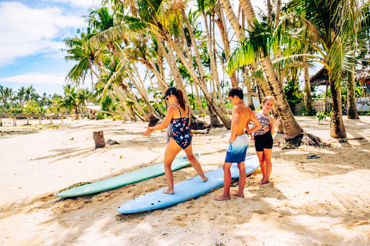 Family surfing in Cloud 9 beach, Siargao Island, Philippines