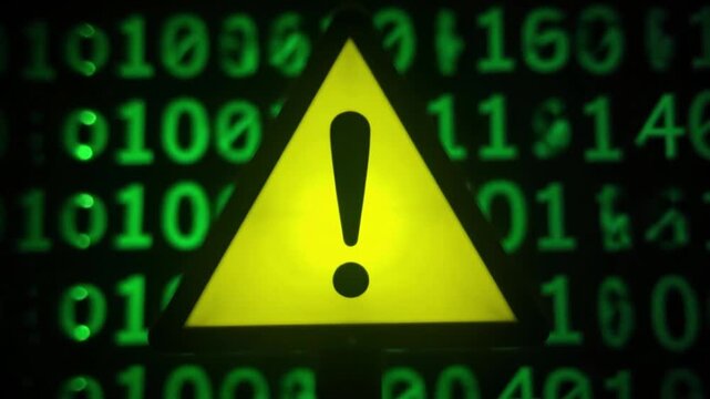Yellow warning sign with exclamation point on a green binary code background displayed on screen