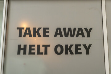 Stockholm, Sweden  A sign in a restaurant window says in Swedish Take Away Helt Okey, Take Away is...