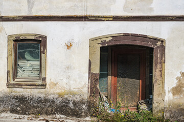 View of a dilapidated house facade in need of renovation