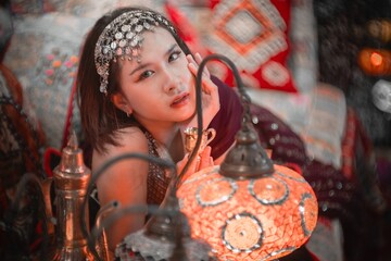 Elegant woman with exotic decor and colorful lanterns in photo