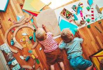 Kids draw and make crafts. Kindergarten or preschool background.