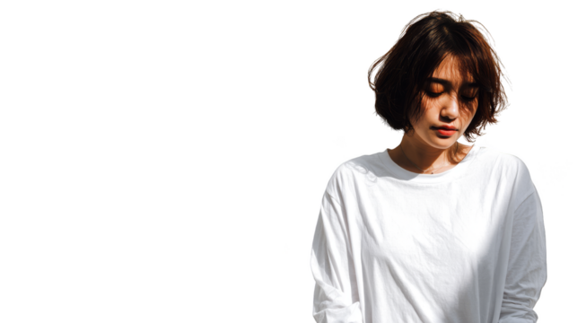 An everyday scene showing a woman dressed in a clean white shirt her hands holding a personal electronic gadget her concentration entirely on the digital display before her.