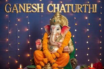 Obraz premium Ganesh Chaturthi, Sacred photorealistic idol of Lord Ganesha glowing with divine aura.