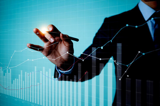 Businessman Analyzing Financial Data and Stock Market Trends with Interactive Graphs and Charts on Virtual Screen for Business Growth and Investment Strategy