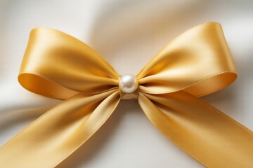 Golden satin ribbon bow with pearl center image photo