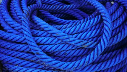 background of blue coiled cordage industrial ropes