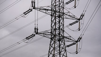 high voltage electric metal tower on a cloudy day