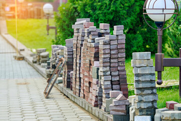 Paving stones stacked neatly in piles during sidewalk repair showing preparation for construction...