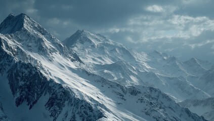 Obraz premium Snowy mountain peaks under a dramatic sky