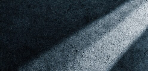 Dark slate texture with sunbeams casting diagonal shadows.