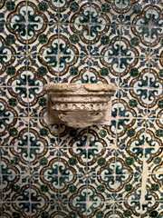 Holy water stoup on tiled wall at San Antolin Cathedral in Palencia, Castilla y Leon