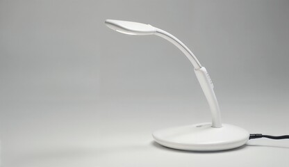 White desk lamp on grey background, modern design, lighting equipment