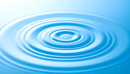 Single drop creates serene ripple effect on clean blue water surface. Concentric circles expand outward, symbolizing impact, purity, and tranquil feeling