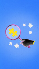 Digital artwork of hand with magnifying glass focusing yellow puzzle piece on blue field. Concept...