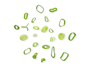 Chopped Spring Onions cut isolated on white background with clipping path. Scattered Fresh Chive , Sliced Green Leek , Scallion Greens Pieces. Top View Flat Lay.