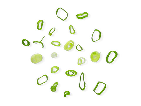 Chopped Spring Onions cut isolated on white background with clipping path. Scattered Fresh Chive , Sliced Green Leek , Scallion Greens Pieces. Top View Flat Lay.