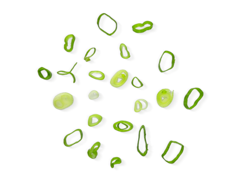 Chopped Spring Onions cut isolated on white background with clipping path. Scattered Fresh Chive , Sliced Green Leek , Scallion Greens Pieces. Top View Flat Lay.