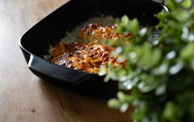 Oven baked chicken fillet with pineapple and cheese crust.