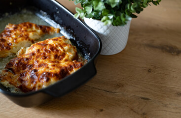 Oven baked chicken fillet with pineapple and cheese crust.