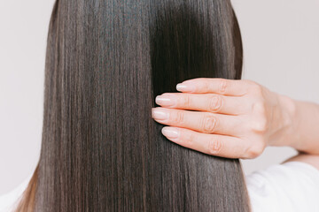 Young caucasian beautiful brunette woman with smooth shiny brown and straight long hair after...