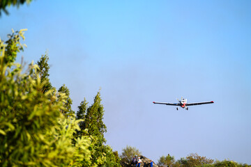 Aerial Firefighting Plane Dropping Water on a Forest Fire