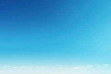 Fototapeta premium Clear blue sky with a gradient of light to dark shades and minimal clouds