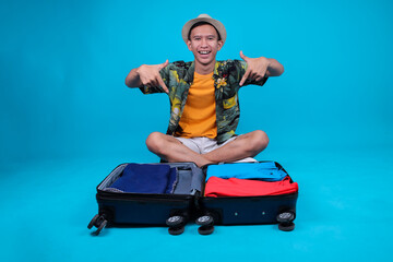Excited Young Man Tourist Preparing For Vacation While Pointing Suitcase, Ready For An Adventure