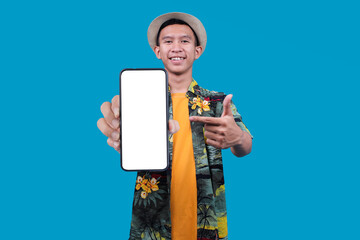 Young Asian Man With Casual Vacation Outfit Pointing To Blank Screen On Phone To Mockup