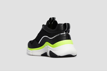 Black sport high thick soled women's shoe, sneaker, 
sports shoe. Footwear, casual streetwear leather shoe for female isolated on white background. Template, mock up, back rear view, heel shoe, detail
