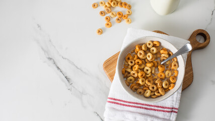 A bowl of round crispy cereal with milk. Healthy breakfast. Copy space