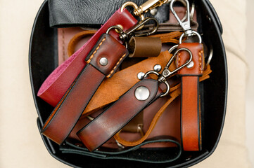 handcrafted leather goods, including notebooks, wallets, and a belt