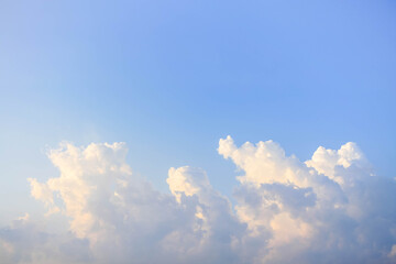 Soft white clouds drifting in clear blue sky creating serene and peaceful atmosphere Copy space