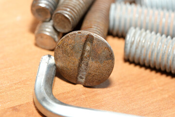 Rusty bolt and screws ready for assembly in a workshop