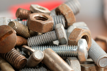 Collection of assorted metal fasteners in a workshop environment